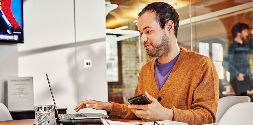 Man in office looking at laptop