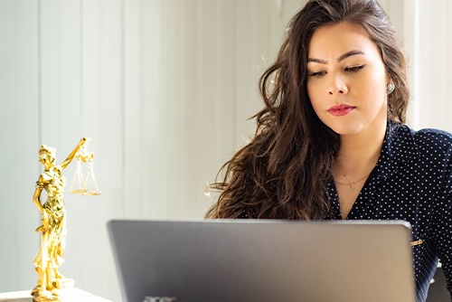 Woman researching salary vs. hourly laws