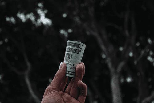 Man holding cash from his supplemental wages