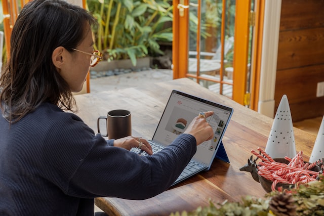 Woman working on laptop.