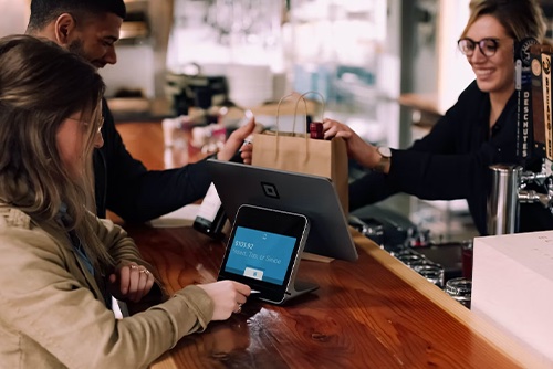 Customer using a tablet to pay for product that is connected to restaurant marketing 