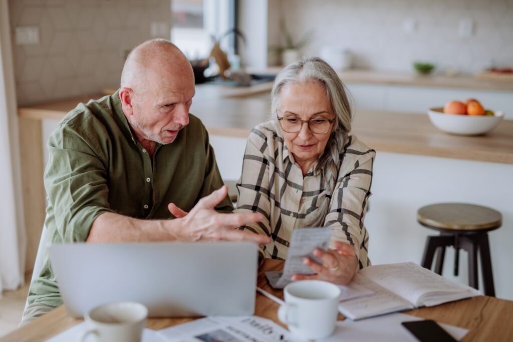 Older couple going over their budget together. 