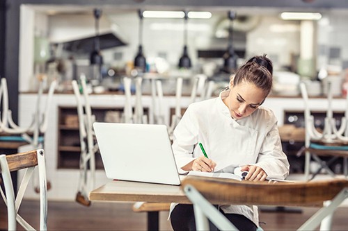 Woman calculating restaurant costs