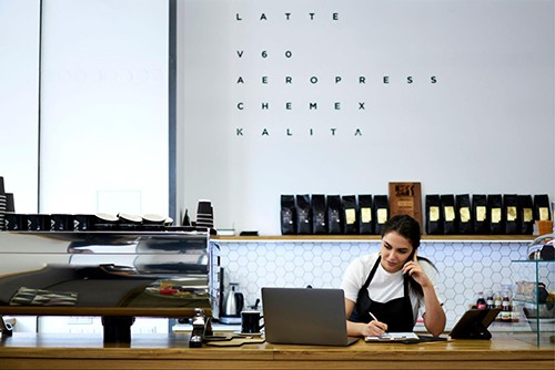 Woman calculating restaurant costs