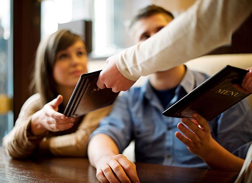 handing menus to customers