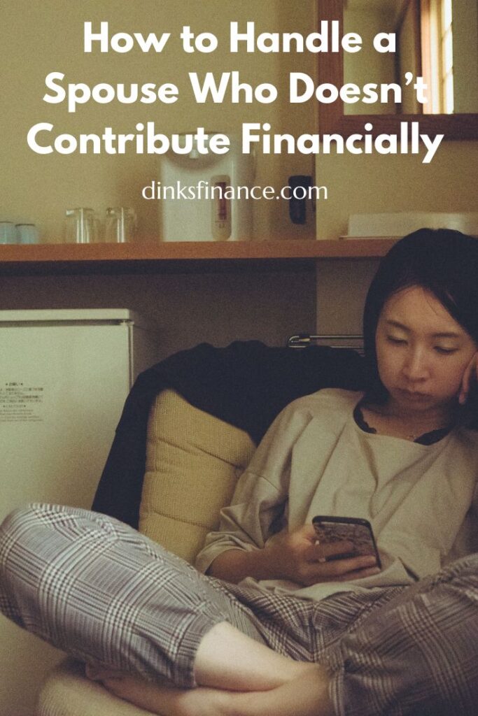 Woman sitting on the couch in her pajamas looking at her phone.