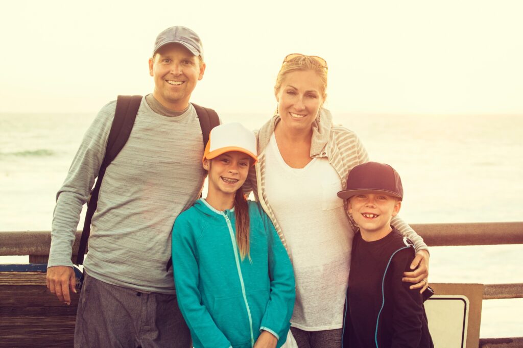 Smiling family--mom, dad, older sister, younger brother