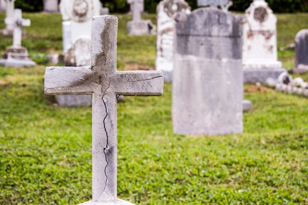 A cracked cross in a cemetery