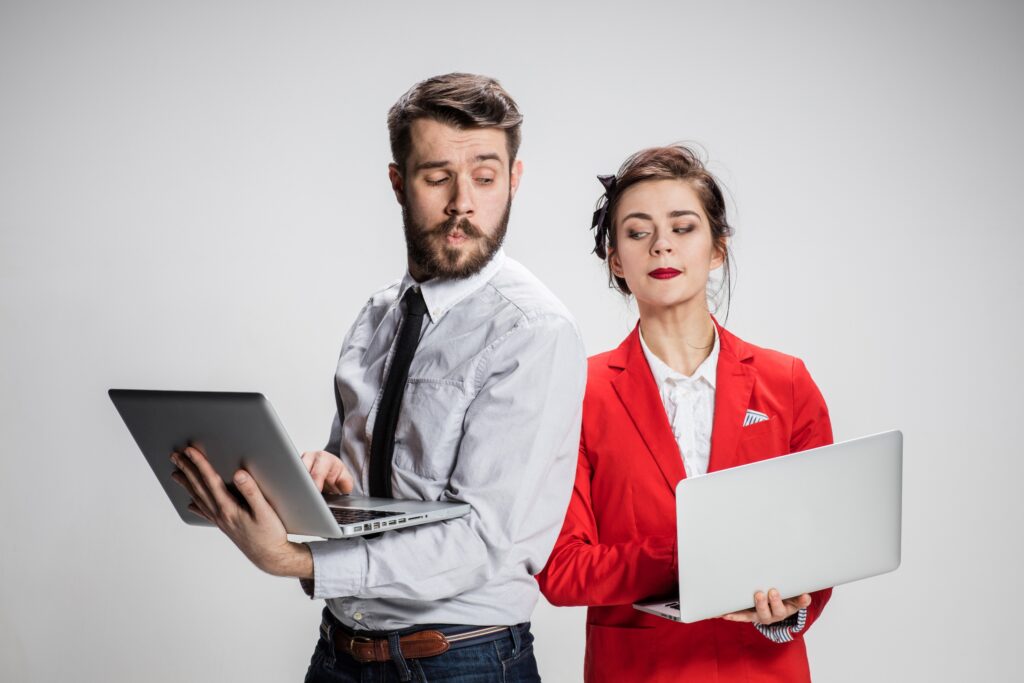 A power couple with each person working on their laptops.