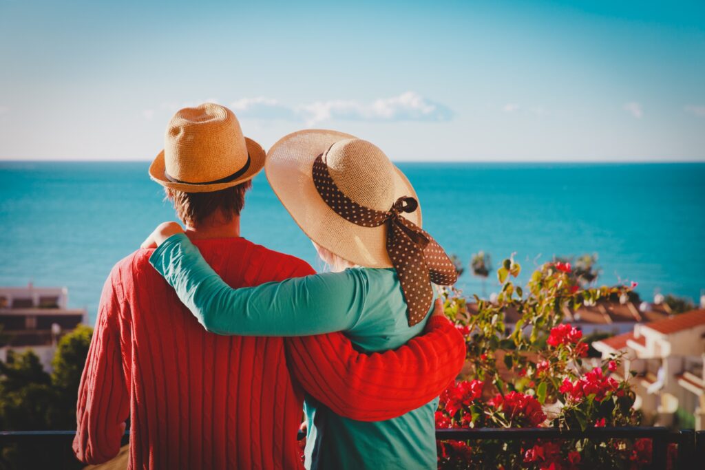 Couple embracing and looking out over a body of water