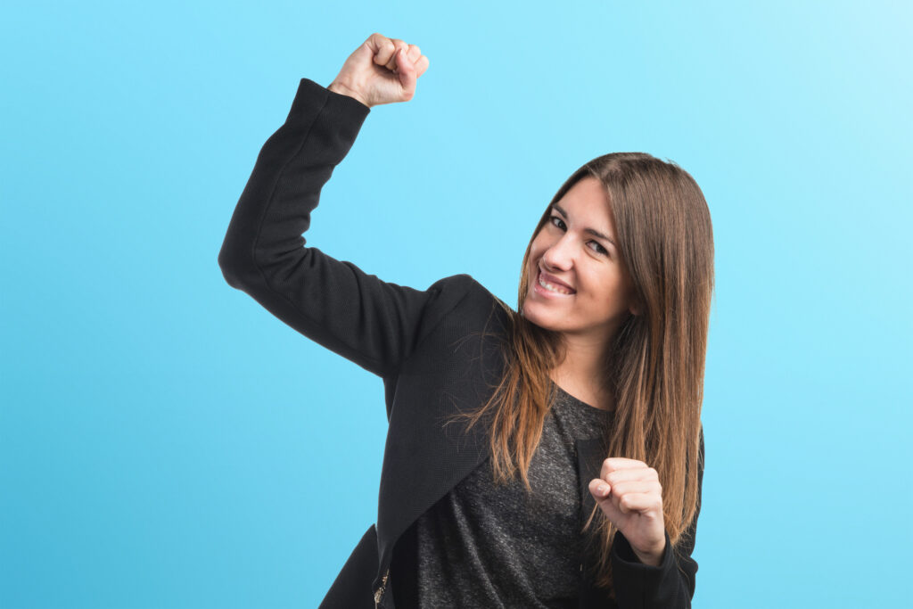 Employee giving a relieved fist pump in a celebratory pose