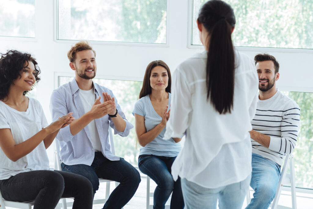 Group of coworkers in a supportive circle listening to each other